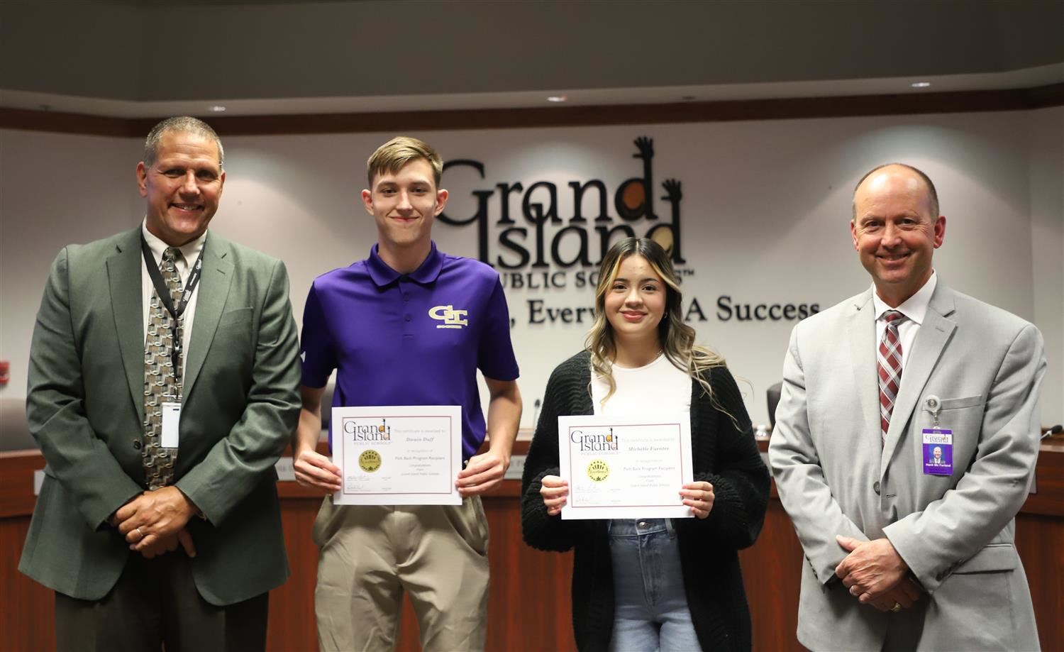 Matt Fisher, GIPS Superintendent, Dwain Duff, Michelle Fuentes, and Hank McFarland, GIPS Board President, smiling.